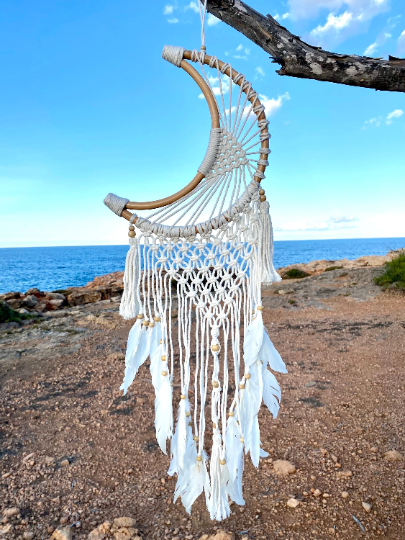 Moon dreamcatcher with feathers and bamboo.