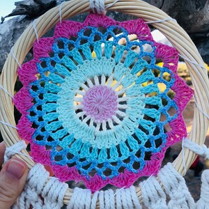 Medium size dreamcatcher with feathers and rattan.