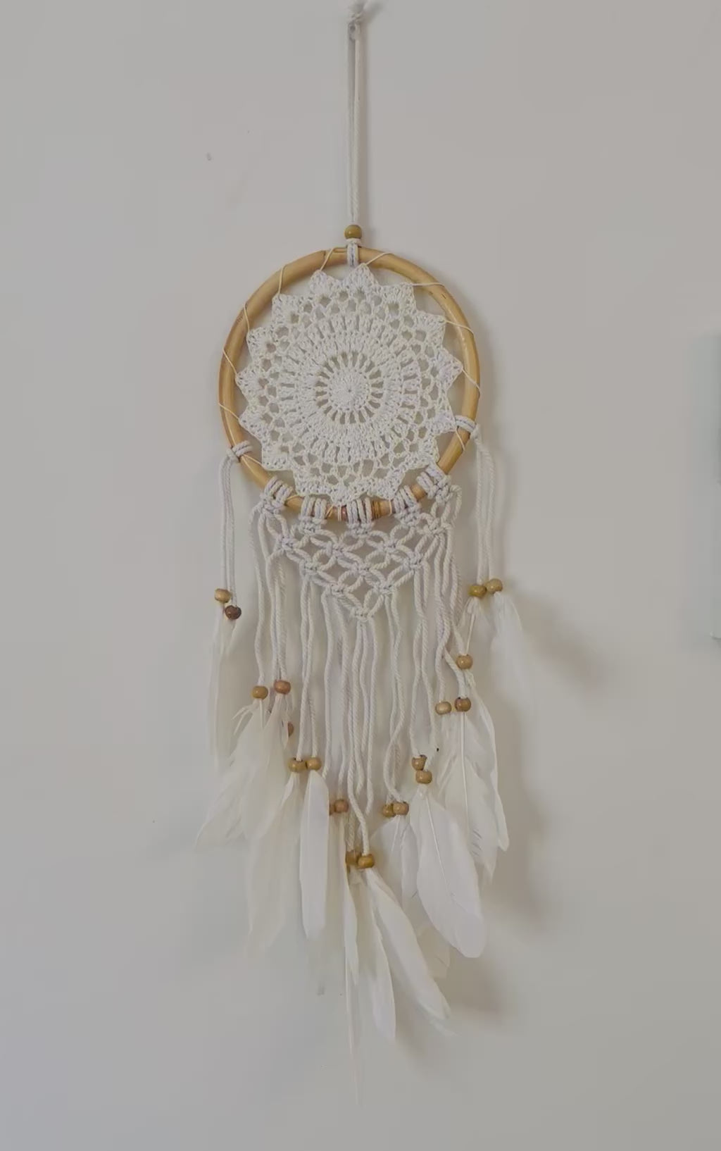 White dream catcher with feathers.