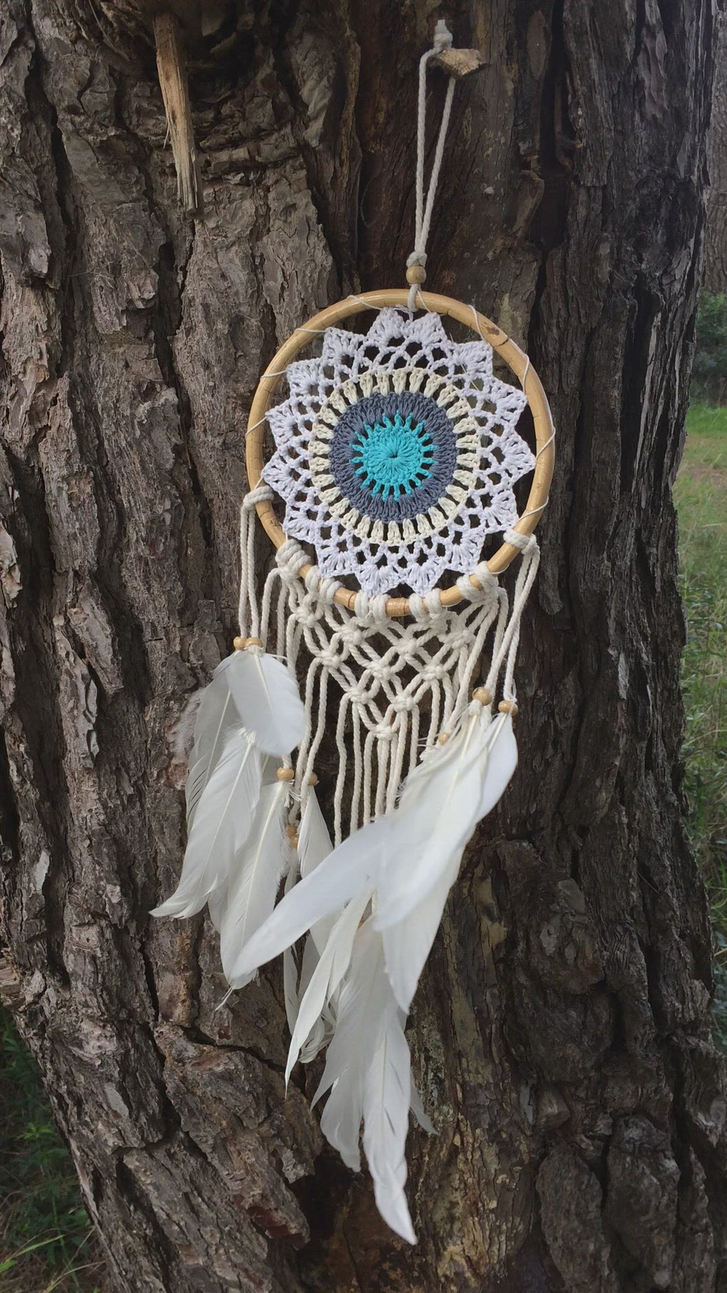 Cute dream catcher with feathers and wooden frame.