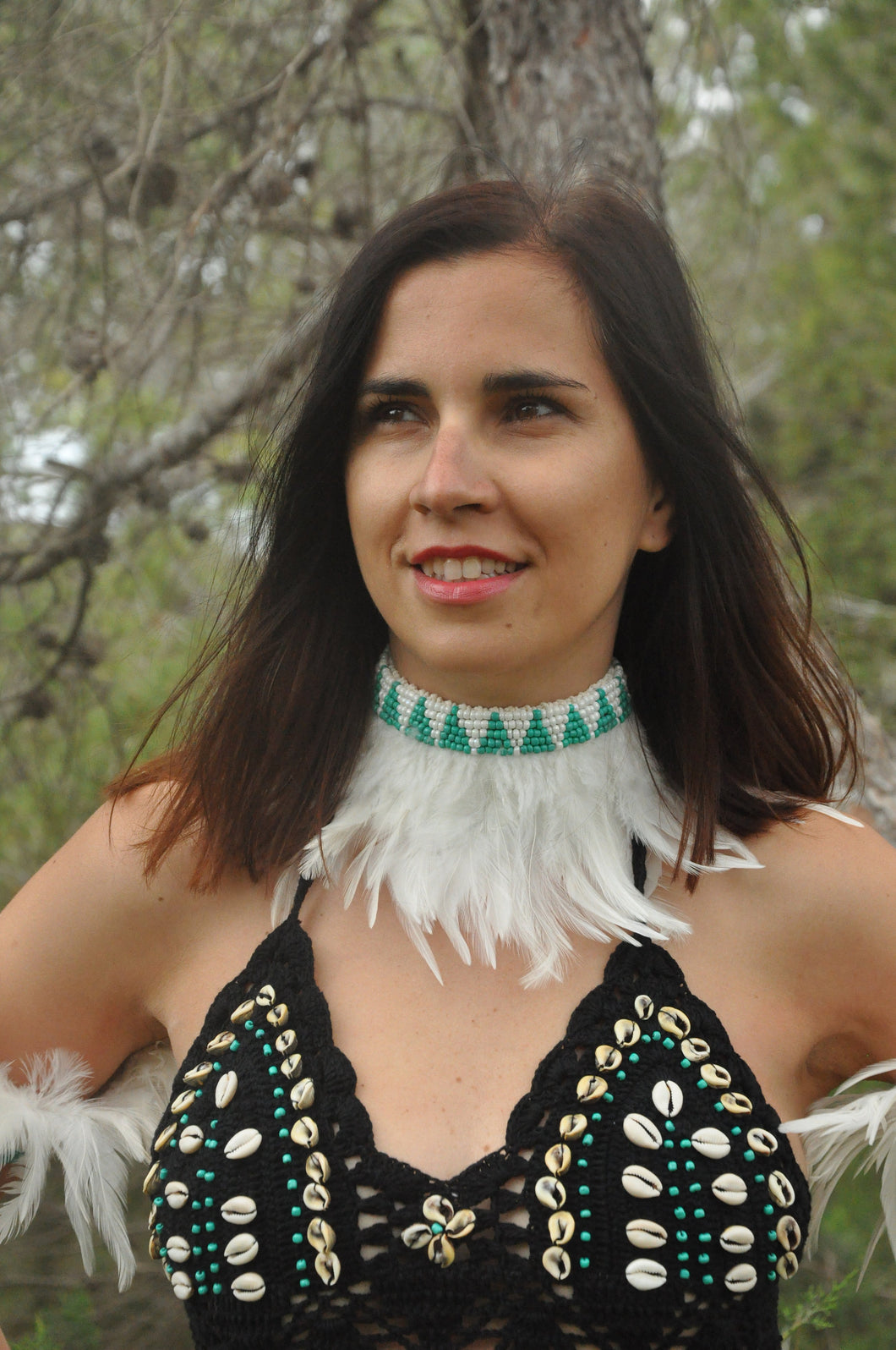 White feathers necklace or headband.