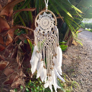 White dream catcher with  feathers.